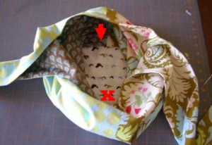 13.  Reach through opening and grasp both base seams on the far side of the bag.