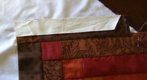 7. Sew short border pieces to dark strips as if they were another strip
