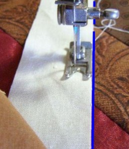 8. Using pressure foot to define seam allowance, align border edge with drawn line and sew through all layers.