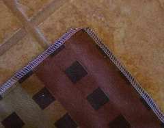 Serged edges and corners trimmed diagonally.