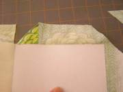 Fold down corner of fabric along cut made for spine.