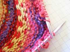 being lifted and ready to be knit together with Popcorn Stitch.