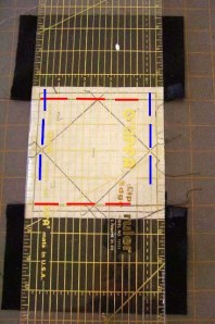 Match seam lines (red) and paper piecing sewing lines (blue) to lines on ruler.