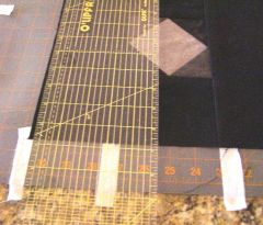 Trimming left edge after aligning edge of ruler with tape.