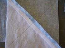 Draw diagonal lines across the BACK of the white/light blue square