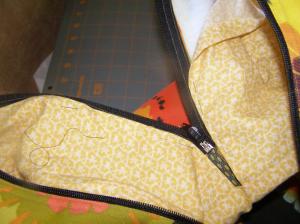 Pin folded edge of lining to Zipper.