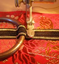 sew back and forth across narrow ribbon to secure rings.