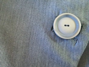 Button detail showing herringbone of fabric.